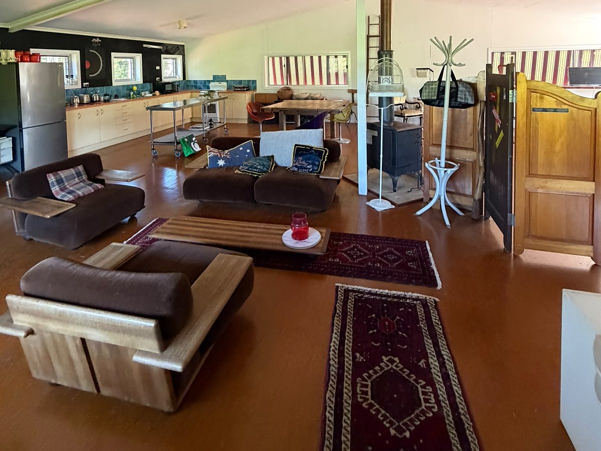 The camp-house living area — sofas, rugs and the kitchen